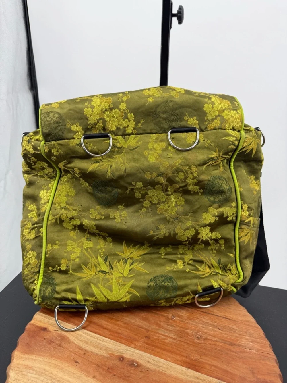 Petunia Pickle Bottom diaper bag in a green, silky, bamboo-themed fabric